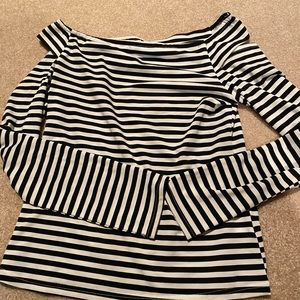 Says medium fits like small shoulder cutout